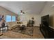 Bright living room with tile floors, comfortable seating, a ceiling fan, and large windows for ample light at 650 N Hawes Rd # 4007, Mesa, AZ 85207