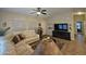 Spacious living room featuring neutral decor, comfortable seating, a ceiling fan, and bright natural light at 650 N Hawes Rd # 4007, Mesa, AZ 85207