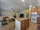 Open-concept living area with kitchen island, comfortable seating, and plenty of natural light from the windows at 650 N Hawes Rd # 4007, Mesa, AZ 85207