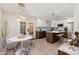 Bright kitchen features modern white cabinets, wood accents, stainless appliances, and a dining area with unique lighting at 6957 E Osborn Rd # A, Scottsdale, AZ 85251