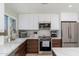 Well-lit kitchen showcasing stainless steel appliances, sleek cabinetry and ample countertop space at 6957 E Osborn Rd # A, Scottsdale, AZ 85251