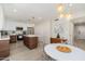 Open kitchen with white cabinets, wood accents, stainless appliances, and dining area with clear chairs at 6957 E Osborn Rd # A, Scottsdale, AZ 85251
