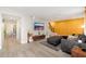 Inviting living room boasts modern decor with a large gray sectional sofa and a striking textured accent wall at 6957 E Osborn Rd # A, Scottsdale, AZ 85251