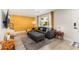 Bright living room showcasing stylish gray sofa, textured gold wall, and large window with bright natural light at 6957 E Osborn Rd # A, Scottsdale, AZ 85251