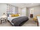 Bright main bedroom featuring a bed with decorative pillows, a ceiling fan, and a closet at 6957 E Osborn Rd # A, Scottsdale, AZ 85251