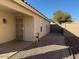 Exterior shot of a home's gravel backyard featuring a stucco wall and greenery at 7232 W Zak Rd, Phoenix, AZ 85043