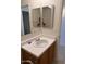 Bathroom vanity with a large mirror and a white countertop and an oak cabinet at 7232 W Zak Rd, Phoenix, AZ 85043