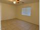 Spacious bedroom with tile floors, a ceiling fan, and a sunlit window at 7232 W Zak Rd, Phoenix, AZ 85043