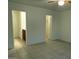 This bedroom features tile flooring, neutral walls, and walk-in closet at 7232 W Zak Rd, Phoenix, AZ 85043