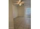 Bedroom featuring a ceiling fan, tile flooring, and natural light from a window at 7232 W Zak Rd, Phoenix, AZ 85043