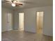 Spacious bedroom featuring tile flooring, ceiling fan, and walk-in closet at 7232 W Zak Rd, Phoenix, AZ 85043