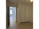 Bedroom with tile flooring, closet, and a doorway to another room at 7232 W Zak Rd, Phoenix, AZ 85043