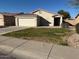 This home features a two-car garage, front lawn, and desert landscaping at 7232 W Zak Rd, Phoenix, AZ 85043