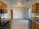 Bright kitchen with tile flooring, oak cabinets, stainless steel appliances, and an island at 7232 W Zak Rd, Phoenix, AZ 85043