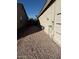 Exterior shot of a home's gravel side yard with a stucco wall at 7232 W Zak Rd, Phoenix, AZ 85043
