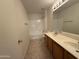 Bright bathroom featuring a double sink vanity and tiled floors at 7266 E Monte Ave, Mesa, AZ 85209