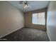 Spacious bedroom with neutral walls, plush carpet, and a ceiling fan at 7266 E Monte Ave, Mesa, AZ 85209
