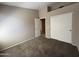 Bedroom with carpet flooring, closet and open door at 7266 E Monte Ave, Mesa, AZ 85209