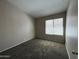 Bedroom with neutral walls, plush carpet, and window with blinds at 7266 E Monte Ave, Mesa, AZ 85209