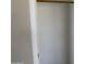 A white closet with a wooden rod at 7266 E Monte Ave, Mesa, AZ 85209