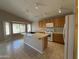 Bright kitchen features an island, gas range, microwave, and wood cabinets at 7266 E Monte Ave, Mesa, AZ 85209