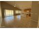 Open floor plan featuring a spacious kitchen with a breakfast bar and backyard access at 7266 E Monte Ave, Mesa, AZ 85209