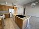 Bright kitchen featuring a functional island, ample cabinet space, and modern appliances at 7266 E Monte Ave, Mesa, AZ 85209