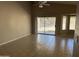 Open living space with ceiling fan, tile floors, and a sliding door to the backyard at 7266 E Monte Ave, Mesa, AZ 85209