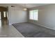 Bright living room featuring neutral walls, carpet, and a window with natural light at 7266 E Monte Ave, Mesa, AZ 85209