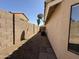Side yard featuring stone groundcover, block fence and HVAC system at 7266 E Monte Ave, Mesa, AZ 85209