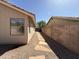 Side yard features a stone walkway, providing a neat and accessible transition to the backyard at 7266 E Monte Ave, Mesa, AZ 85209