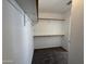 Bright walk-in closet featuring clean, white walls and carpeted floor at 7266 E Monte Ave, Mesa, AZ 85209