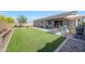 Spacious backyard with artificial turf, patio, gazebo, BBQ, and playset at 7512 W Warner St, Phoenix, AZ 85043