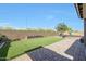 Beautiful backyard featuring lush artificial turf, paver patio and planter, great for entertaining at 7512 W Warner St, Phoenix, AZ 85043