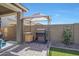 Backyard patio with gazebo, outdoor furniture, BBQ, and paver stones at 7512 W Warner St, Phoenix, AZ 85043