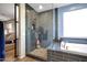 Sleek bathroom showcasing a walk-in shower with dark subway tile, a soaking tub, and glass enclosure at 7512 W Warner St, Phoenix, AZ 85043
