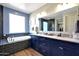Luxurious bathroom with double vanities, soaking tub, and walk-in shower with dark subway tile at 7512 W Warner St, Phoenix, AZ 85043