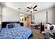 Comfortable bedroom with a ceiling fan, closet, and attached bathroom at 7512 W Warner St, Phoenix, AZ 85043