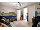 Bright bedroom featuring vibrant decor, plush carpet, and a view into an ensuite bathroom at 7512 W Warner St, Phoenix, AZ 85043