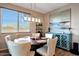 This dining area features a contemporary light fixture and large window for enjoying your meals at 7512 W Warner St, Phoenix, AZ 85043