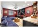 Basement entertainment room featuring a large tv screen, couch, and wet bar at 7512 W Warner St, Phoenix, AZ 85043