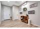 Welcoming entryway featuring stylish decor, a wooden shelf, and light tile flooring at 7512 W Warner St, Phoenix, AZ 85043
