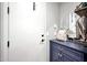 Charming entryway with a white door, blue cabinet, and stylish decorative elements at 7512 W Warner St, Phoenix, AZ 85043