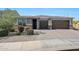Charming home featuring desert landscaping, a brick driveway, and a convenient three-car garage at 7512 W Warner St, Phoenix, AZ 85043