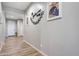 Inviting hallway decorated with Gathering photos and leading to various rooms of the house at 7512 W Warner St, Phoenix, AZ 85043