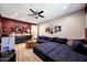 Entertainment room with a wet bar area featuring custom cabinets and a large sectional sofa at 7512 W Warner St, Phoenix, AZ 85043