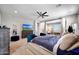 Spacious main bedroom with a large bed, tv, and a view into the relaxing sitting room at 7512 W Warner St, Phoenix, AZ 85043
