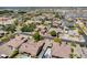 High-angle aerial showcasing a residential neighborhood with diverse homes, green spaces, and community streets at 8024 W Vista Ave, Glendale, AZ 85303