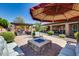Beautiful backyard featuring a fire pit, lounge chairs, and covered patio with stylish outdoor furniture at 8024 W Vista Ave, Glendale, AZ 85303
