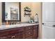 Bathroom vanity with granite countertops and decorative shelving at 8024 W Vista Ave, Glendale, AZ 85303